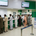 Person using smartphone for NADRA PakID online CNIC application and tracking.