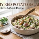 Classic red potato salad recipe with creamy mustard dressing, fresh dill, and red-skinned potatoes in a white bowl